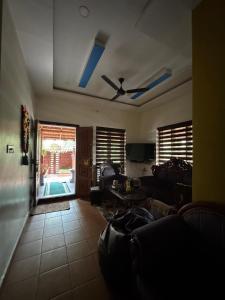 a living room with a couch and a ceiling fan at Krishnalayam Heritage Villa in Elimala
