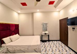 a hotel room with a bed and a tv at Dove Inn Hotel wahdat road in Lahore +69 photos