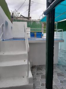 a set of white stairs in a building at Hadiqah event venue in Mangangpico +10 photos