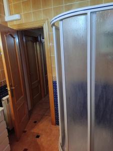a walk in shower in a bathroom next to a door at Villa CiTe- jardines/BBQ/terrazas/ para familias in Teruel