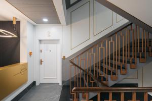 a hallway with stairs and a white door at Native Apartments Długa 24I3 in Kraków