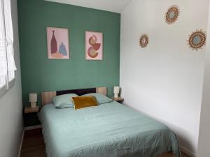 a bedroom with a bed and three pictures on the wall at Loft, Studio and Love Rooms in Bourg-Saint-Christophe +85 photos