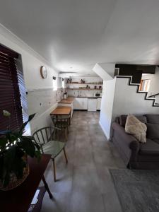 a living room with a couch and a table at Koetshuis on High Street in Paarl