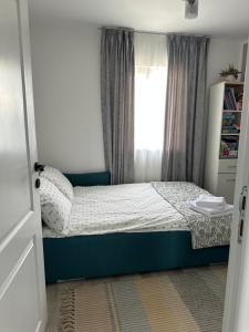 a small bedroom with a bed and a window at Cabanuta in Brașov in Braşov