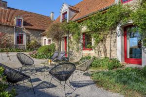 a group of chairs sitting in front of a building at La Demeure de la Poterie, Wimille & Wimereux in Wimille