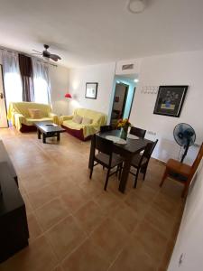 a living room with a couch and a table at Apartamento María Isabel en Los Collados Golf - Aguilas in Águilas