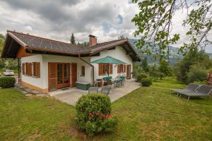 a small house with a table and chairs in a yard at Montafon Alpen Chalet in Vandans