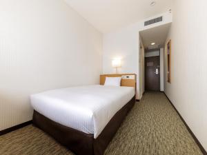 Ένα ή περισσότερα κρεβάτια σε δωμάτιο στο Nishitetsu Inn Kurosaki