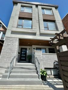 a house with a staircase in front of it at Bright Luxurious 2 Bedroom Apartment in Toronto