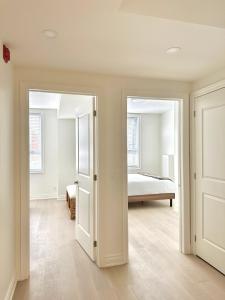 a bedroom with a bed and a door leading into a room at Bright Luxurious 2 Bedroom Apartment in Toronto