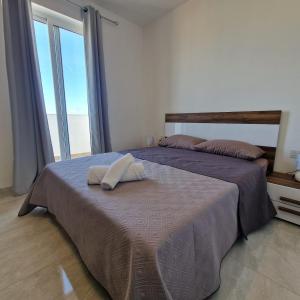 Postel nebo postele na pokoji v ubytování Chaltan Apartment - Raħal Ġdid
