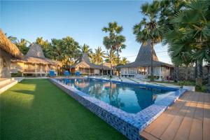 an image of a swimming pool at a resort at Blue Lagoon Pool View Bungalow, Single Room with Queen Bed and Bathtub in Lakahembi