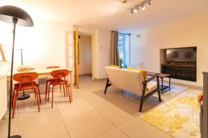 a living room with a dining room table and chairs at Private 1BD Flat near Gloucester Docks in Gloucester +14 photos