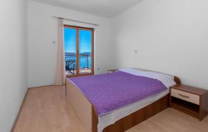 a bedroom with a purple bed and a balcony at Villa with pool Riviera in Crikvenica +42 photos