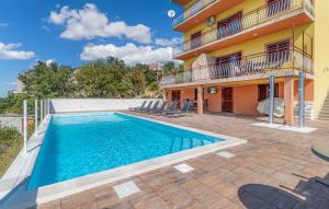 a villa with a swimming pool in front of a building at Villa with pool Riviera in Crikvenica