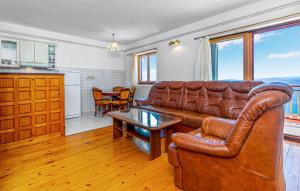 a living room with a leather couch and a table at Villa with pool Riviera in Crikvenica