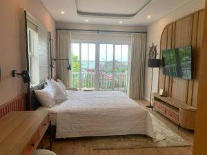 Postel nebo postele na pokoji v ubytování DREAM HOUSE 2 NovaWorld Phan Thiết