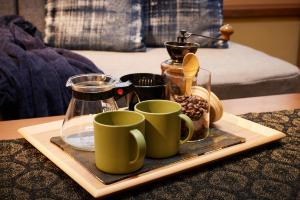 a tray of coffee mugs and cups on a table at Minn Nijo-jo in Kyoto