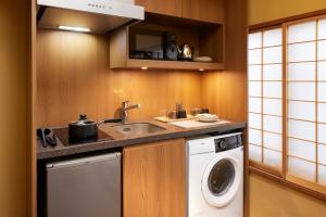 a kitchen with a sink and a washing machine at Minn Nijo-jo in Kyoto