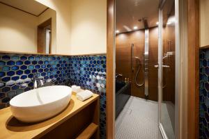 a bathroom with a sink and a shower at Minn Nijo-jo in Kyoto