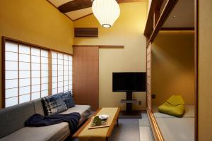 a living room with a couch and a tv at Minn Nijo-jo in Kyoto
