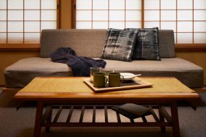 a coffee table with two cups on top of a couch at Minn Nijo-jo in Kyoto