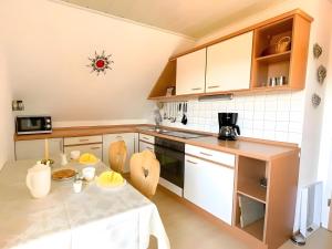 a kitchen with a table and a counter top at Haus Rosenfelder Fewo Abendsonne in Bernau im Schwarzwald