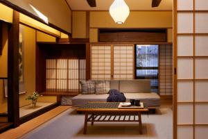 a living room with a couch and a table at Minn Nijo-jo in Kyoto