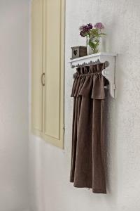 a towel rack with a plant on a wall at Nice house in Linneryd in Linneryd +14 photos
