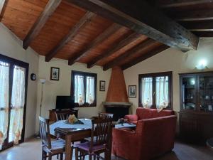 a living room with a table and chairs at Da Nonna Maria Ozieri in Ozieri