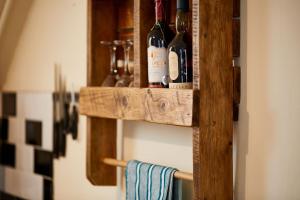 a couple of bottles of wine on a wooden shelf at Fishermans Rest in Lossiemouth