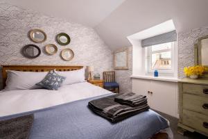 a bedroom with a bed and mirrors on the wall at Fishermans Rest in Lossiemouth