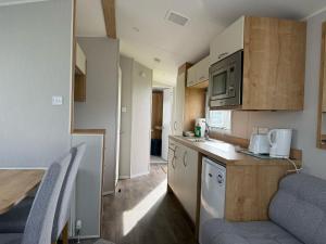 a small kitchen with a table and a counter top at Glenlea in Selsey
