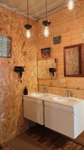 two sinks in a bathroom with wooden walls at 歸海Back to the Ocean in Green Island