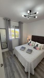 a bedroom with a large bed and a window at Apartamento Florkin vacacional acogedor recién reformado con vistas al mar in Torrox +40 photos