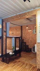 a room with two bunk beds and a wooden floor at 歸海Back to the Ocean in Green Island