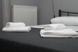 two towels are sitting on top of a bed at Fertoun apartment in Chaïdeftón +15 photos