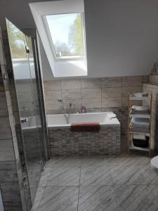 a bathroom with a bath tub and a window at Ubytování Dědinka in Mladkov +23 photos