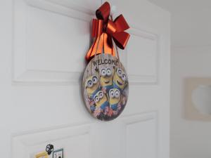 a clock hanging on a ceiling with a bow at Minionz House #Free parking in Seoul