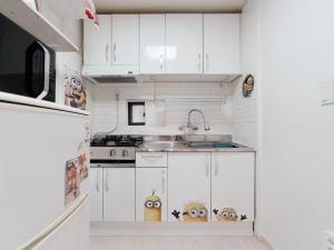 a kitchen with white cabinets with monsters on them at Minionz House #Free parking in Seoul