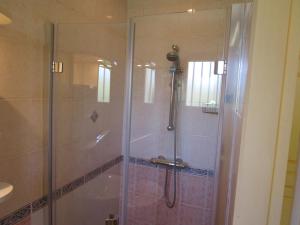 a shower with a glass door in a bathroom at Locatlantique in Aytré