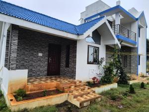 a house with a staircase in front of it at Twilight Home stay in Yelagiri