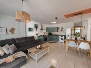 a living room with a couch and a table at RenTenerife Magec Swing & Sun Amarilla Golf in San Miguel de Abona