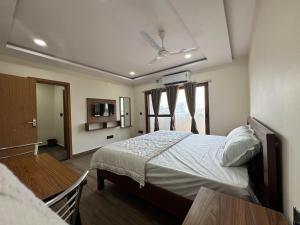 a bedroom with a large bed and a window at hOTEL MADHAVA RESIDENCY in Kākināda