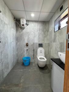 a bathroom with a toilet and a sink at hOTEL MADHAVA RESIDENCY in Kākināda