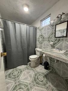 ein Badezimmer mit Toilette, Dusche und Waschbecken in der Unterkunft Centrally located apartment 2 blocks from the sea in Cozumel