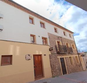 a large white building with a brown door at Boro-Vía Láctea in Borobia