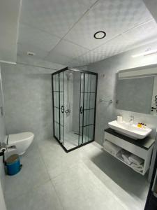 a bathroom with a glass shower and a sink at Rodis hotel in Gumuldur +67 photos