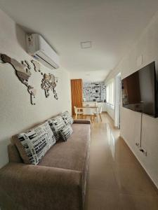 a living room with a couch and a map on the wall at Departamento 12 Tower in Salta