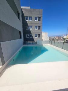 a large swimming pool on the side of a building at Departamento 12 Tower in Salta